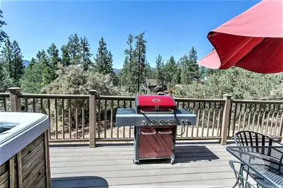 a barbecue grill sitting on a wooden deck at Grandpas axe # 1775 in Big Bear Lake