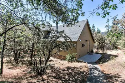 a small house in the middle of a field at Grandpas axe # 1775 in Big Bear Lake