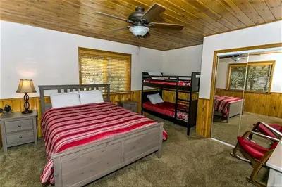 a bedroom with two bunk beds and a ceiling fan at Grandpas axe # 1775 in Big Bear Lake