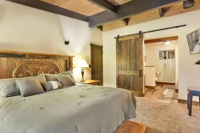 a bedroom with a large bed with a wooden headboard at Eagle point lodge #2080 in Big Bear Lake