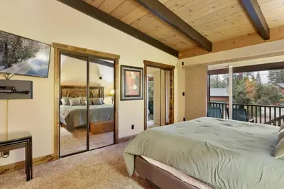 a bedroom with a bed and a balcony at Eagle point lodge #2080 in Big Bear Lake
