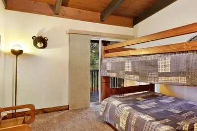 a bedroom with a bunk bed and a window at Eagle point lodge #2080 in Big Bear Lake