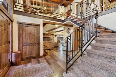 a staircase in a home with a wooden door at Eagle point lodge #2080 in Big Bear Lake