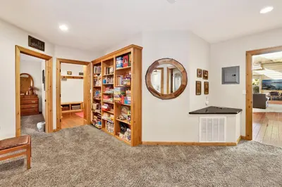 a home library with a mirror and book shelves at Gold rush lodge #2352 in Big Bear Lake