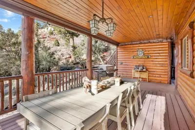 a wooden deck with a table and chairs on it at Gold rush lodge #2352 in Big Bear Lake