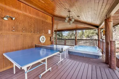 a room with two ping pong tables on a deck at Gold rush lodge #2352 in Big Bear Lake