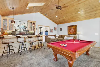 a living room with a pool table and a kitchen at Gold rush lodge #2352 in Big Bear Lake
