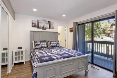 a bedroom with a bed and a large window at Blue jay getaway #2082 in Big Bear Lake