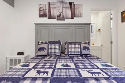 a bedroom with a bed with a blue and white quilt at Blue jay getaway #2082 in Big Bear Lake
