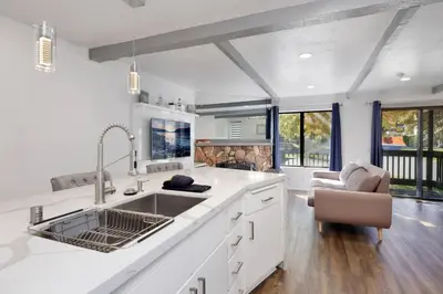 a white kitchen with a sink and a couch at Blue jay getaway #2082 in Big Bear Lake