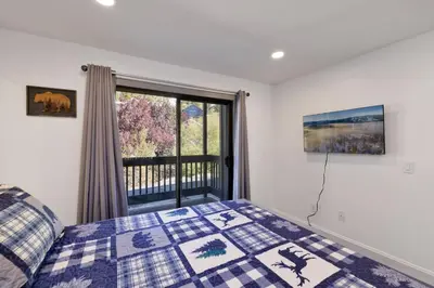 a bedroom with a bed and a window at Blue jay getaway #2082 in Big Bear Lake
