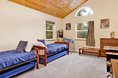 a living room with two beds and a piano at Mount berkley #2367 in Big Bear Lake