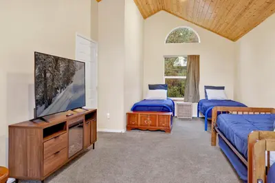 a bedroom with two beds and a flat screen tv at Mount berkley #2367 in Big Bear Lake