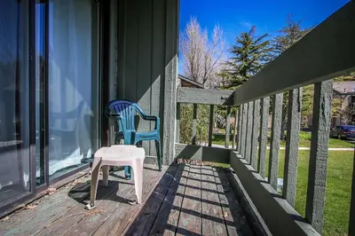 a porch with two chairs and a stool on it at Boulder creek #1417 in Big Bear Lake