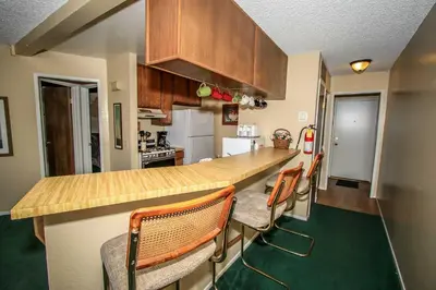 a kitchen with a counter and some chairs in it at Boulder creek #1417 in Big Bear Lake