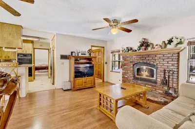 a living room with a brick fireplace and a table at Crestwood summit #2119 in Big Bear Lake
