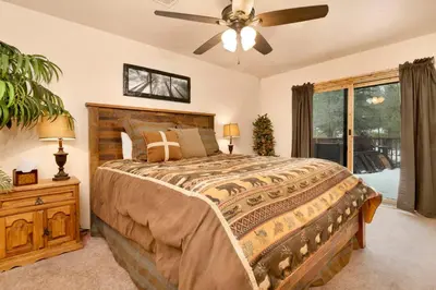 a bedroom with a bed and a ceiling fan at Swiss delight #2244 in Big Bear Lake