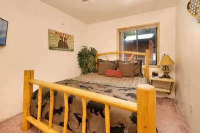 a bedroom with a wooden bed in a room at Swiss delight #2244 in Big Bear Lake