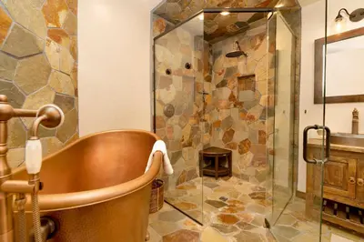 a bathroom with a tub and a glass shower at Swiss delight #2244 in Big Bear Lake