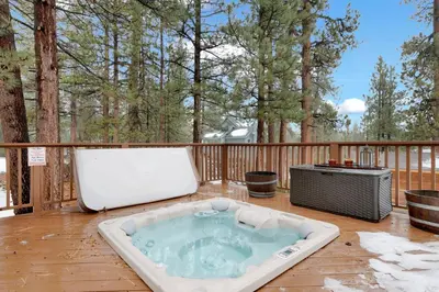 a hot tub on a deck with a television at Swiss delight #2244 in Big Bear Lake