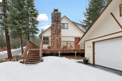 a house with a deck and a chimney at Swiss delight #2244 in Big Bear Lake