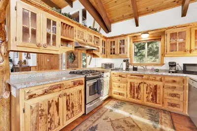 a kitchen with wooden cabinets and a stove top oven at Fishermans paradise #1792 in Big Bear Lake