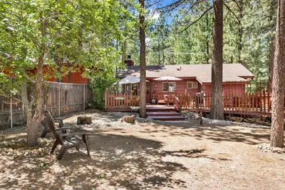 a log cabin with a bench in front of it at Pine cone cottage #2191 in Big Bear Lake