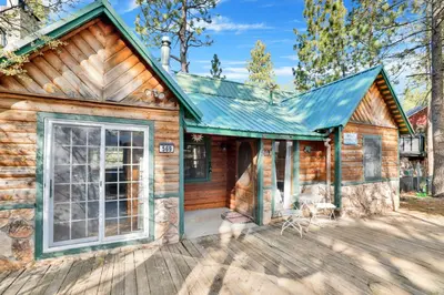a log cabin with a large door on a deck at Temple Lake Views#2298 in Big Bear Lake