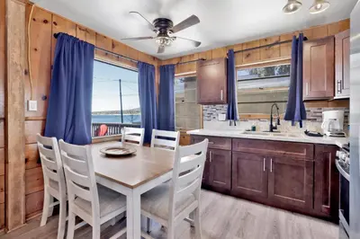 a dining room with a table and chairs in a kitchen at Lakeside #109 in Big Bear Lake