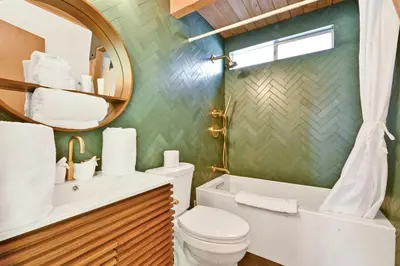 a bathroom with a toilet and a sink and a mirror at QUAIL'S CALL #2415 in Big Bear Lake