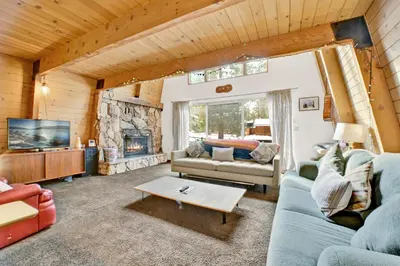 a living room with a couch and a fireplace at QUAIL'S CALL #2415 in Big Bear Lake