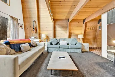 a living room with a couch and a table at QUAIL'S CALL #2415 in Big Bear Lake