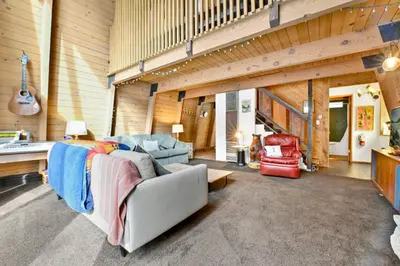 a living room with a couch and chairs and a guitar at QUAIL'S CALL #2415 in Big Bear Lake