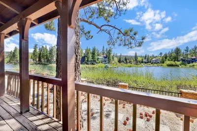 a deck with a view of a lake and trees at Breezy two #113 in Big Bear Lake
