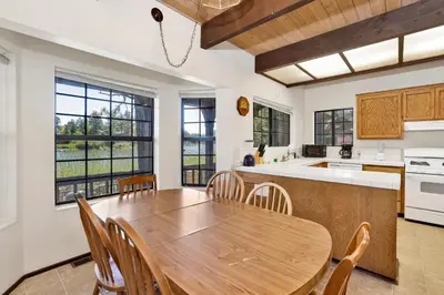 a large kitchen with a wooden table and chairs at Breezy two #113 in Big Bear Lake