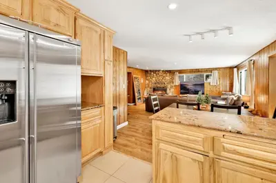 a kitchen with wooden cabinets and a stainless steel refrigerator at Conklin paradise #1993 in Big Bear Lake