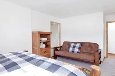 a bedroom with a couch and a chair at The alps lodge #2142 in Big Bear Lake