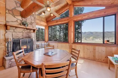 a dining room with a table and a fireplace at The alps lodge #2142 in Big Bear Lake