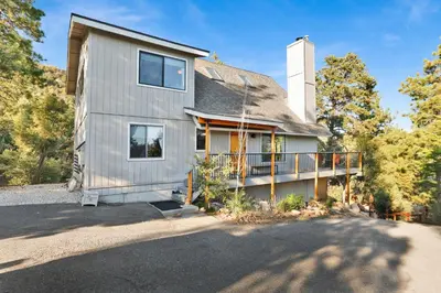 a house with a balcony on a driveway at Chimney Peak Chalet#2048 in Big Bear City