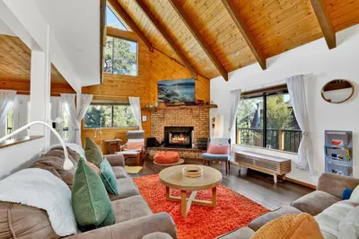 a living room with a couch and a fireplace at Chimney Peak Chalet#2048 in Big Bear City