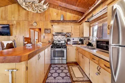 a kitchen with wooden cabinets and stainless steel appliances at Casa catalina #667 in Big Bear Lake