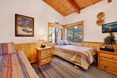a bedroom with two beds and a window at Casa catalina #667 in Big Bear Lake
