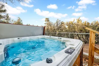 a jacuzzi tub on the balcony of a house at A hidden asset #2379 in Big Bear Lake