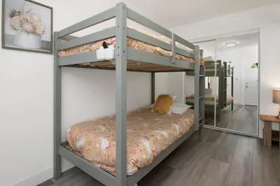 a bedroom with two bunk beds with a mirror at Sweet retreat 2 #2333 in Big Bear Lake