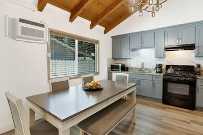 a kitchen with a wooden table and a dining room at Sweet retreat 2 #2333 in Big Bear Lake