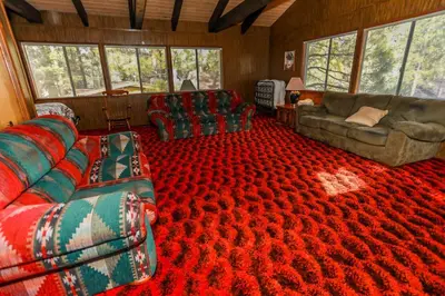 a living room with couches and a red carpet at MAKIN' MEMORIES AT SUMMIT #1683 in Big Bear Lake