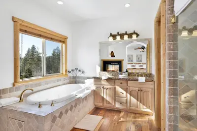 a large bathroom with a tub and a window at Cozy lakeview hideaway #2261 in Fawnskin