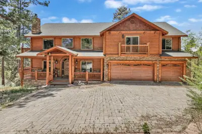 a log home with a large driveway in front of it at Cozy lakeview hideaway #2261 in Fawnskin