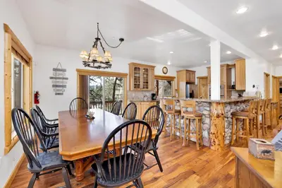 a kitchen and dining room with a wooden table and chairs at Cozy lakeview hideaway #2261 in Fawnskin