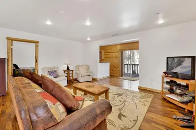a living room with a couch and a tv at Cozy lakeview hideaway #2261 in Fawnskin